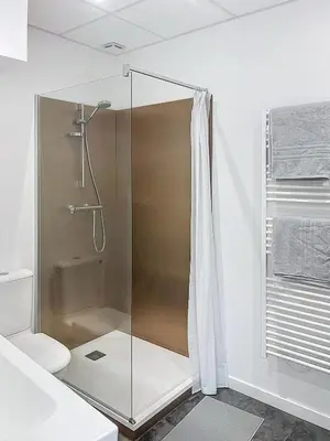 a shower with a glass door in a bathroom at La Suite Lauragaise - Studio climatisé in Villefranche-de-Lauragais