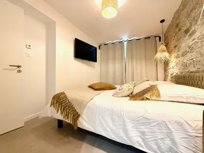 a bedroom with a large bed with a wall at 43 Belle vue - Luxury in Carcassonne