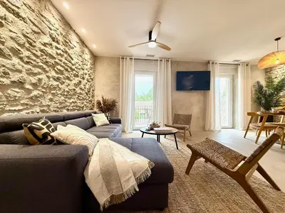 a living room with a couch and a stone wall at 43 Belle vue - Luxury in Carcassonne