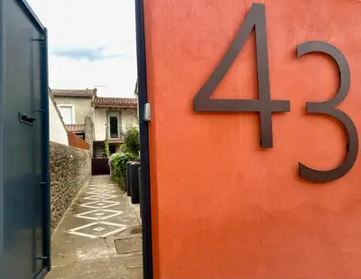 an orange door with the number on it at 43 Belle vue - Luxury in Carcassonne