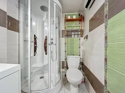 a bathroom with a toilet and a glass shower at La Feuilleraie - Maison de vacance à Leucate in Leucate