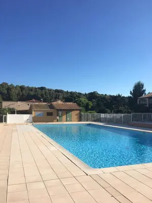 a swimming pool in a yard with a tile floor at La Feuilleraie - Maison de vacance à Leucate in Leucate
