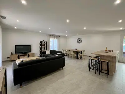 a large living room with a couch and a table at Chez Nous, Chez Vous ! in La Redorte