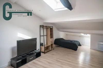 a bedroom with a flat screen tv and a bed at Cœur de ville studio lumineux in Castelnaudary