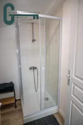 a shower with a glass door in a bathroom at Cœur de ville studio lumineux in Castelnaudary