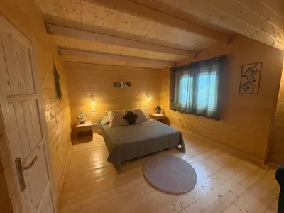 a bedroom with a bed and a window in a room at Chalet Chêne-Pin in Boutenac
