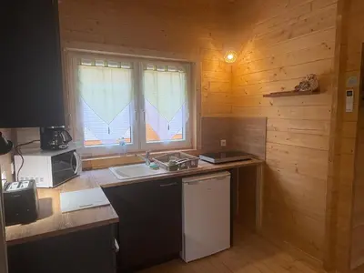 a kitchen with a counter and a sink and a window at Chalet Chêne-Pin in Boutenac