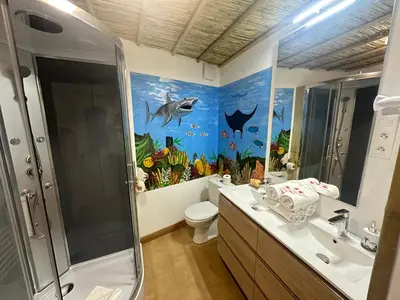 a bathroom with a fish mural on the wall at Studio Tahiti du Cloitre in Narbonne