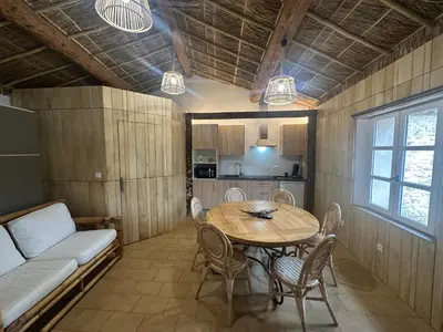 a room with a table and chairs and a couch at Studio Tahiti du Cloitre in Narbonne