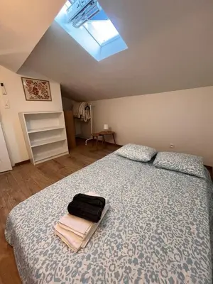 a bedroom with a bed with a suitcase on it at Quiet house for 12 people near Cité Carcassonne in Carcassonne