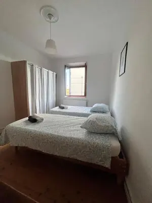 two beds in a bedroom with a window at Quiet house for 12 people near Cité Carcassonne in Carcassonne
