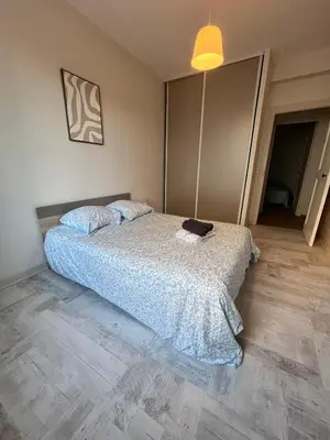 a bedroom with a bed with a blue comforter at Quiet house for 12 people near Cité Carcassonne in Carcassonne