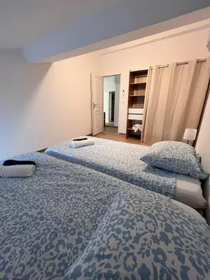a bedroom with two beds with blue comforter at Quiet house for 12 people near Cité Carcassonne in Carcassonne
