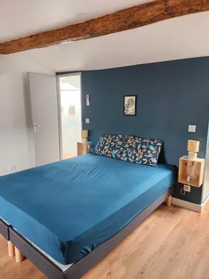 a bedroom with a blue bed with a blue wall at Grand T4 lumineux 200 m du port in Castelnaudary