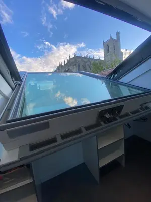 a glass window with a view of a castle at Superbe Appartement Atypique Combles - Neuf avec Vue in Narbonne