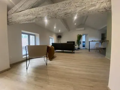 a living room with a table and chairs at Superbe Appartement Atypique Combles - Neuf avec Vue in Narbonne
