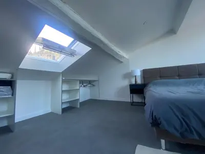 a bedroom with a bed and a window at Superbe Appartement Atypique Combles - Neuf avec Vue in Narbonne