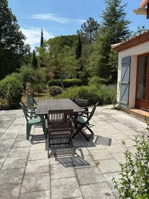a wooden table and chairs on a patio at Vacation home with pool in Quillan