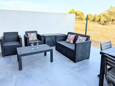 a patio with two chairs and a table and two chairs at Évasion à la Villa Sérénité, nature et confort in Port-la-Nouvelle