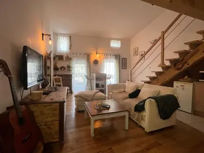 a living room with a couch and a guitar at Grain de sel in Sigean