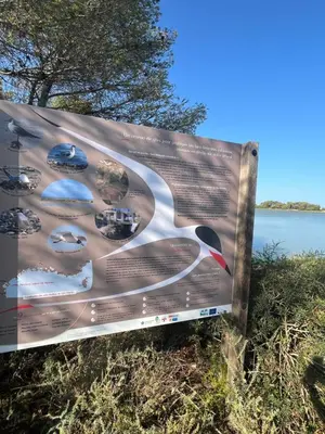 a sign in the grass next to a body of water at Grain de sel in Sigean