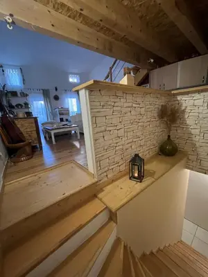 a room with a staircase and a brick wall at Grain de sel in Sigean