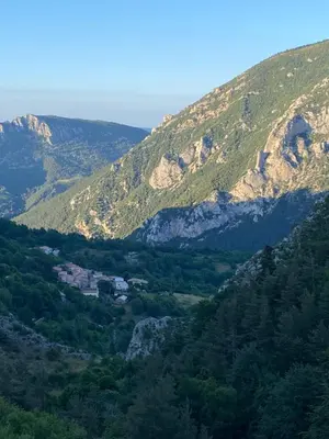 a view of a mountain range with trees and houses at Hameau le Caunil in Salvezines