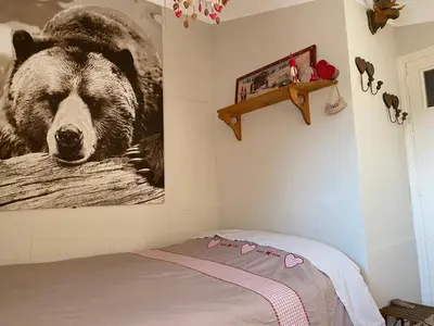 a bedroom with a large picture of a bear on the wall at Hameau le Caunil in Salvezines