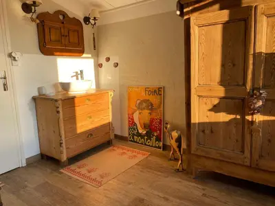 a bathroom with a sink and a wooden dresser at Hameau le Caunil in Salvezines