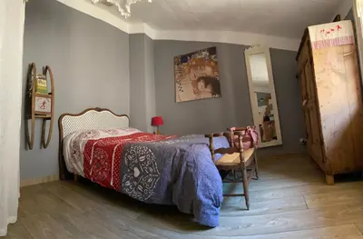 a bedroom with a bed and a wooden floor at Hameau le Caunil in Salvezines