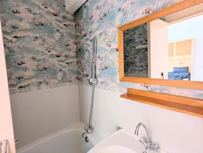a bathroom with a sink and a bath tub at Cocoon sur le port de Gruissan, parking & piscine in Gruissan