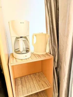 a coffee maker on a shelf in a refrigerator at Cocoon sur le port de Gruissan, parking & piscine in Gruissan