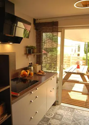 a kitchen with a sink and a counter top at Gruissan Terrasse jardin cosy et au calme in Gruissan