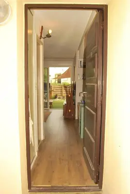 a hallway with a door leading into a house at Gruissan Terrasse jardin cosy et au calme in Gruissan