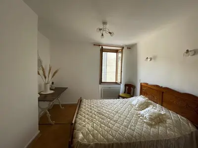 a bedroom with a bed and a window at Maison gorges de la Pierre lys in Belvianes-et-Cavirac