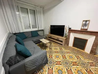 a living room with a couch and a fireplace at Maison gorges de la Pierre lys in Belvianes-et-Cavirac