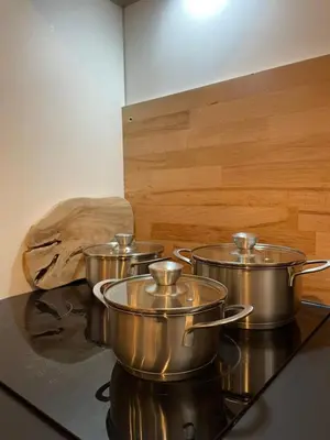 a group of four pots on top of a stove at L'Opale - Duplex Calme & Confort en Hypercentre in Castres