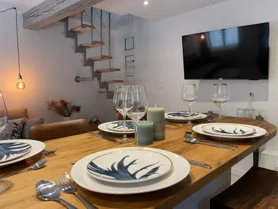 a dining room table with plates and wine glasses at L'Opale - Duplex Calme & Confort en Hypercentre in Castres