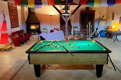 a living room with two chairs and a table at Grand gîte de charme 190 m2 avec billard, jardin et cheminée- idéal familles ou entre amis - proche Canal du Midi in Lagarde