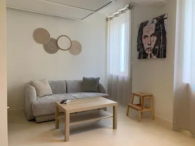 a living room with a couch and a coffee table at Studio Gili Meno in Narbonne