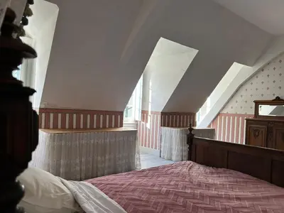 a bedroom with a bed in an attic at Château Belle au Bois Dormant in Cambounet-sur-le-Sor