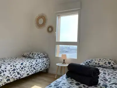 a bedroom with two beds and a window at T3 with large roof-top terrace, harbor view in Gruissan