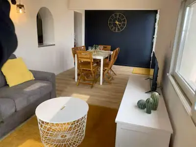 a living room with a couch and a dining room table at T3 with large roof-top terrace, harbor view in Gruissan