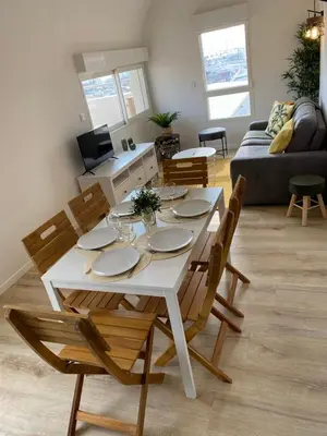 a white table and chairs in a living room at T3 with large roof-top terrace, harbor view in Gruissan