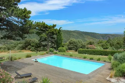 a swimming pool in the middle of a yard at Au Cammazou in Villanière