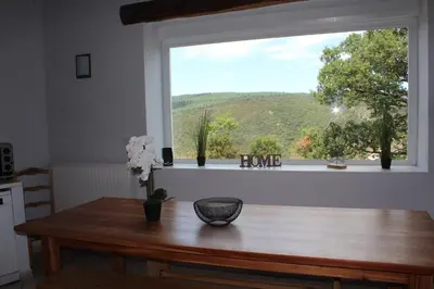 a window in a kitchen with a table and a view at Au Cammazou in Villanière
