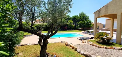 a swimming pool in a yard with a tree at Maison de vacances avec piscine en bord de mer in Lapalme