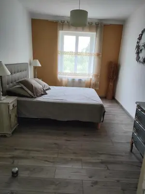 a bedroom with a large bed and a window at La maison gourmande in Alzonne