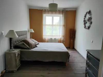 a bedroom with a large bed and a window at La maison gourmande in Alzonne