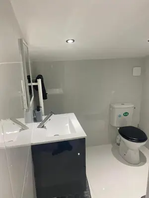 a white bathroom with a toilet and a sink at Maison accueillante à Trèbes avec 2 chambres in Trèbes